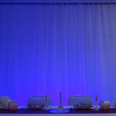 Elegant event table setting with Eiffel Tower centerpiece and decorative details.