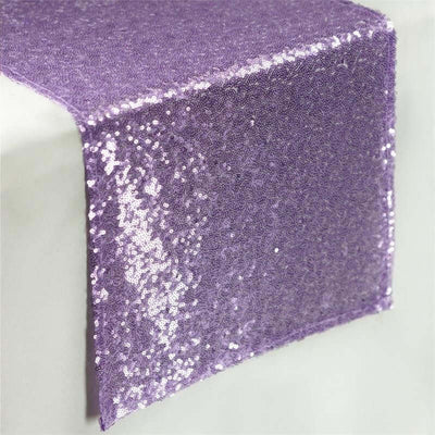 Purple sequin table runner on a plain backdrop