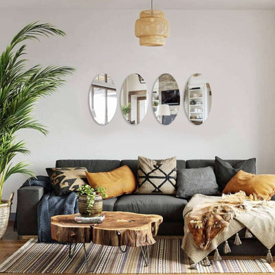 Cozy living room with a dark sofa, decorative pillows, and stylish mirrors on the wall.