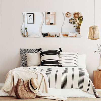 Cozy bedroom with stylish decor, striped blankets, and wall art.