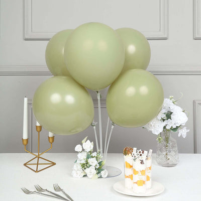 Green balloons with decor and dessert on a table setting.