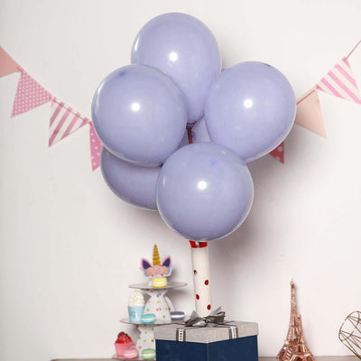 Purple balloons tied to a gift box, decorated with a festive banner in the background.