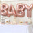 Rose gold "BABY" balloons at a festive dessert table for a baby shower.