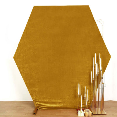 Hexagonal mustard backdrop with gold candle holders.