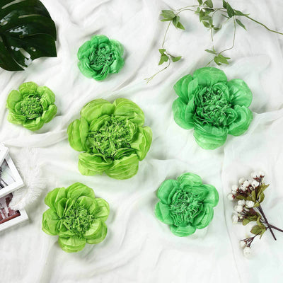 Green decorative flower arrangement on a soft white background.