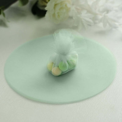 Mint green party favor bag with colorful candies, set on a soft background.