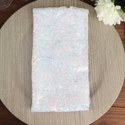 Iridescent sequin fabric on a wooden surface