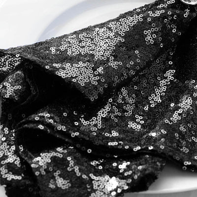 Black sequin fabric draped elegantly on a plate.