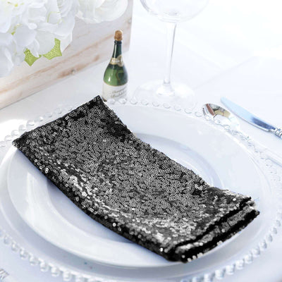 Black sequin napkin elegantly folded on a decorative plate