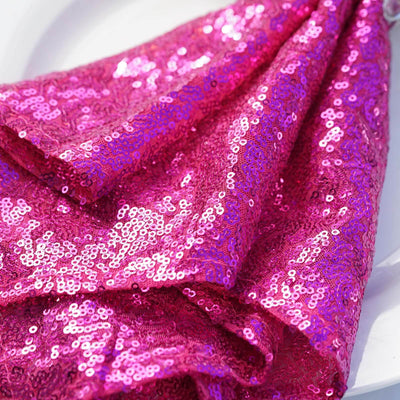 Pink sequin fabric draped elegantly on a white plate.