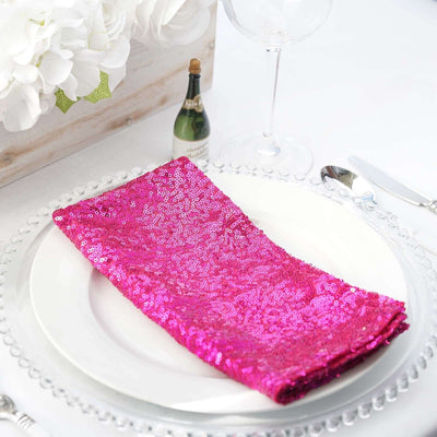 Pink sequin table napkin elegantly placed on a white plate.