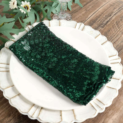 Green sequin table napkin on a decorative plate
