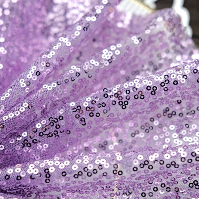 Purple sequined fabric with shimmering details.