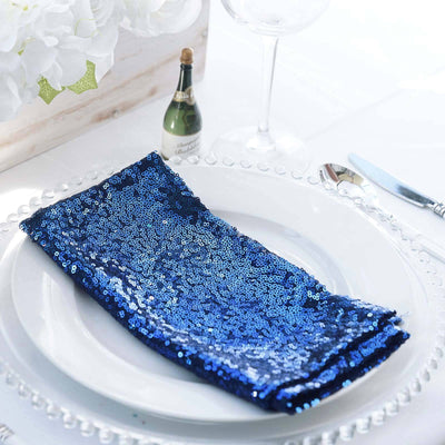 Blue sequin table napkin on a plate set for an elegant dining experience.