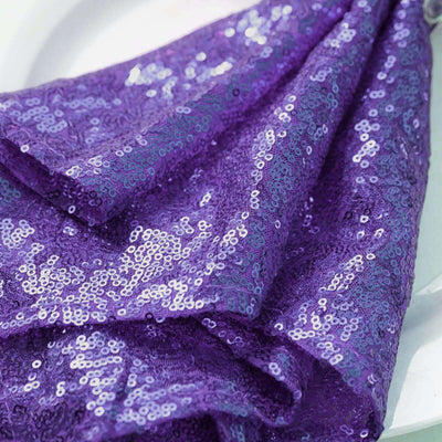 Purple sequin fabric draped elegantly on a plate.