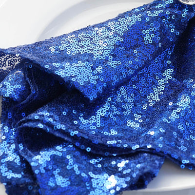 Blue sequin fabric draped elegantly on a white plate.
