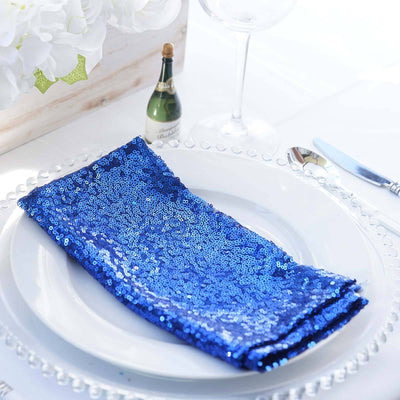 Blue sequin napkin elegantly arranged on a white plate.