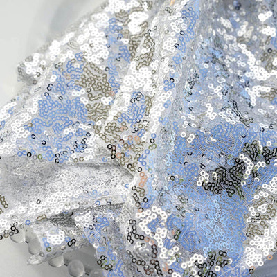 Shiny blue and silver sequin fabric draped elegantly.