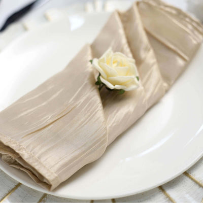 Elegant beige napkin with a decorative rose on a white plate.