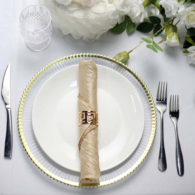 Elegant table setting with gold napkin holder on a white plate.