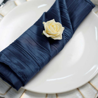 Navy blue napkin with a white rose on a plate