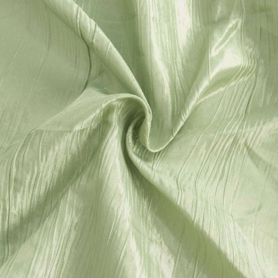 Green textured fabric with a subtle sheen and wrinkled appearance.