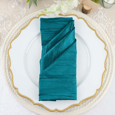 Teal satin napkin elegantly folded on a decorative plate