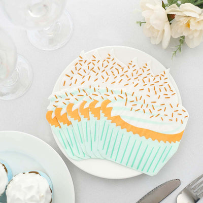 Colorful cupcake-shaped paper plates arranged on a white table setting.