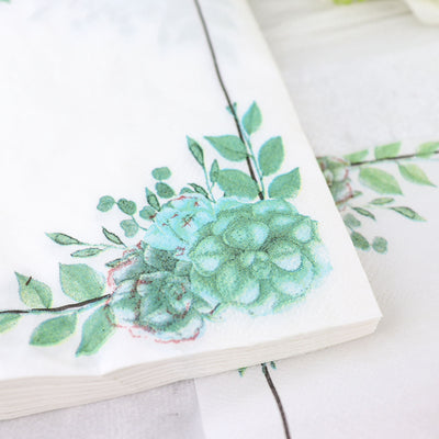 Floral patterned napkins featuring green leaves and blossoms.