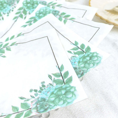 Floral decorative napkins with green succulents on a white background.
