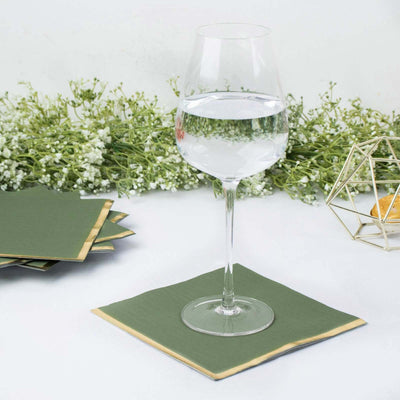 Green coasters with a wine glass on a table, surrounded by decorative flowers.