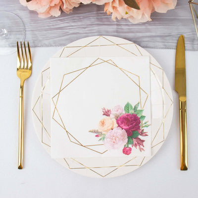 Floral napkin on a stylish plate with gold utensils for elegant dining.
