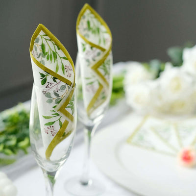 Decorative napkins in champagne flutes at a beautifully set table.