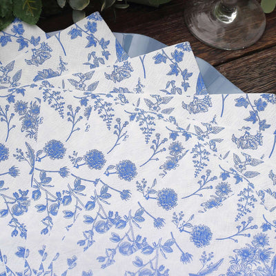 Blue floral patterned paper napkins on a wooden table.