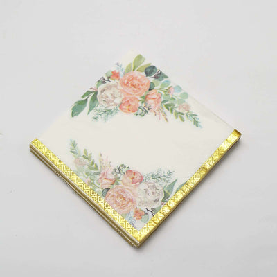 Floral design napkin with gold trim on a white background.