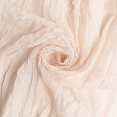 Light pink textured fabric with a soft, flowing appearance.