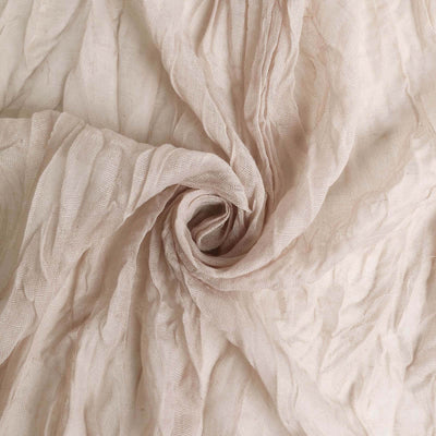 Wrinkled beige fabric texture in a spiral pattern.