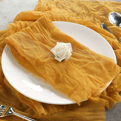 Mustard yellow table runner with a white rose on a plate.