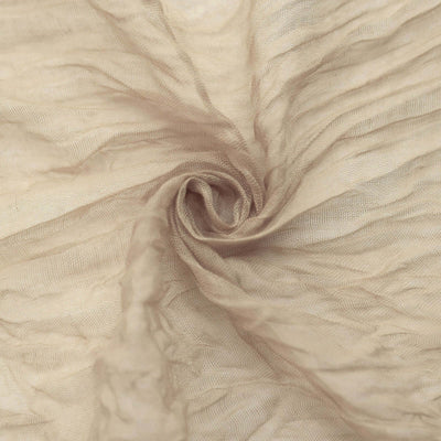 Textured beige fabric swirling in a circular pattern.