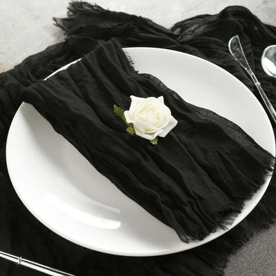 Black chiffon table runner styled on a white plate with a decorative rose.