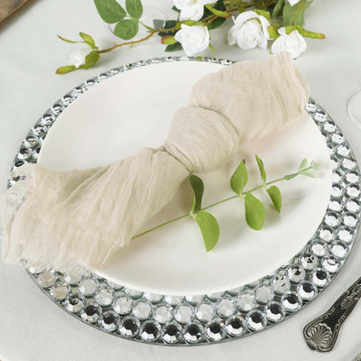 Elegant linen napkin with greenery on a decorative plate setting.