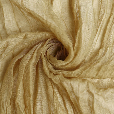 Gold textured fabric swirl close-up for elegant decor and design.