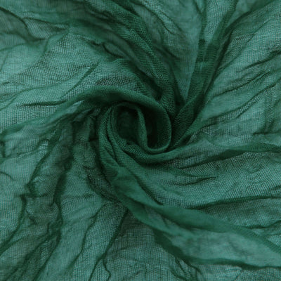 Green textured fabric swirl close-up for creative projects.