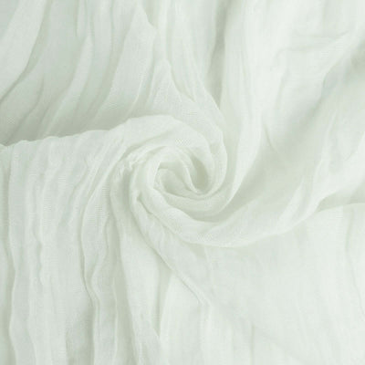 Textured white fabric in a soft, swirling arrangement.