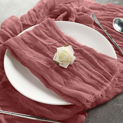 Elegant pink table runner with a white rose on a plate.