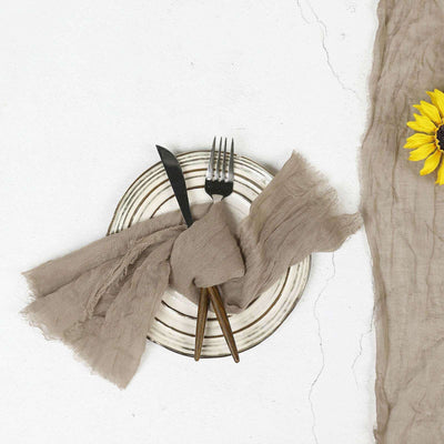 Stylish plate with cutlery and linen napkin, accented by a sunflower