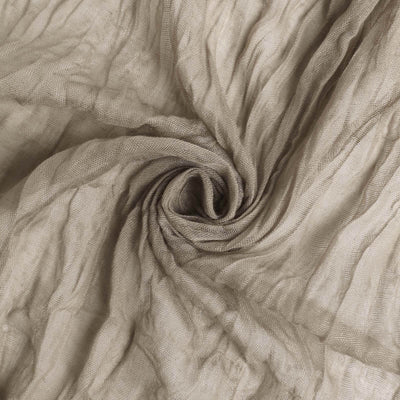 Textured beige fabric swirling in a spiral pattern.