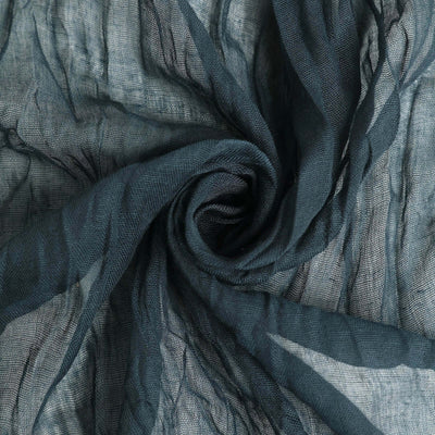 Textured dark teal fabric in a swirling pattern.