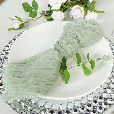 Green textured napkin with leaf accent on a plate.
