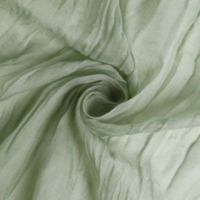 Soft green sheer fabric with flowing texture and delicate folds.